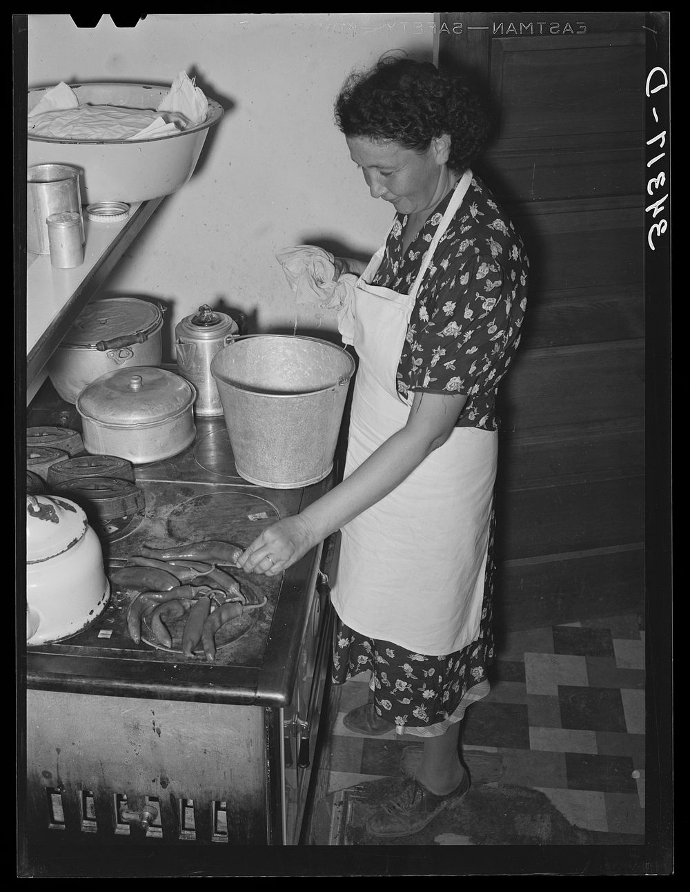 [Untitled photo, possibly related to: Spanish-American woman removing baked bread from oven farm near Taos, New Mexico] by…