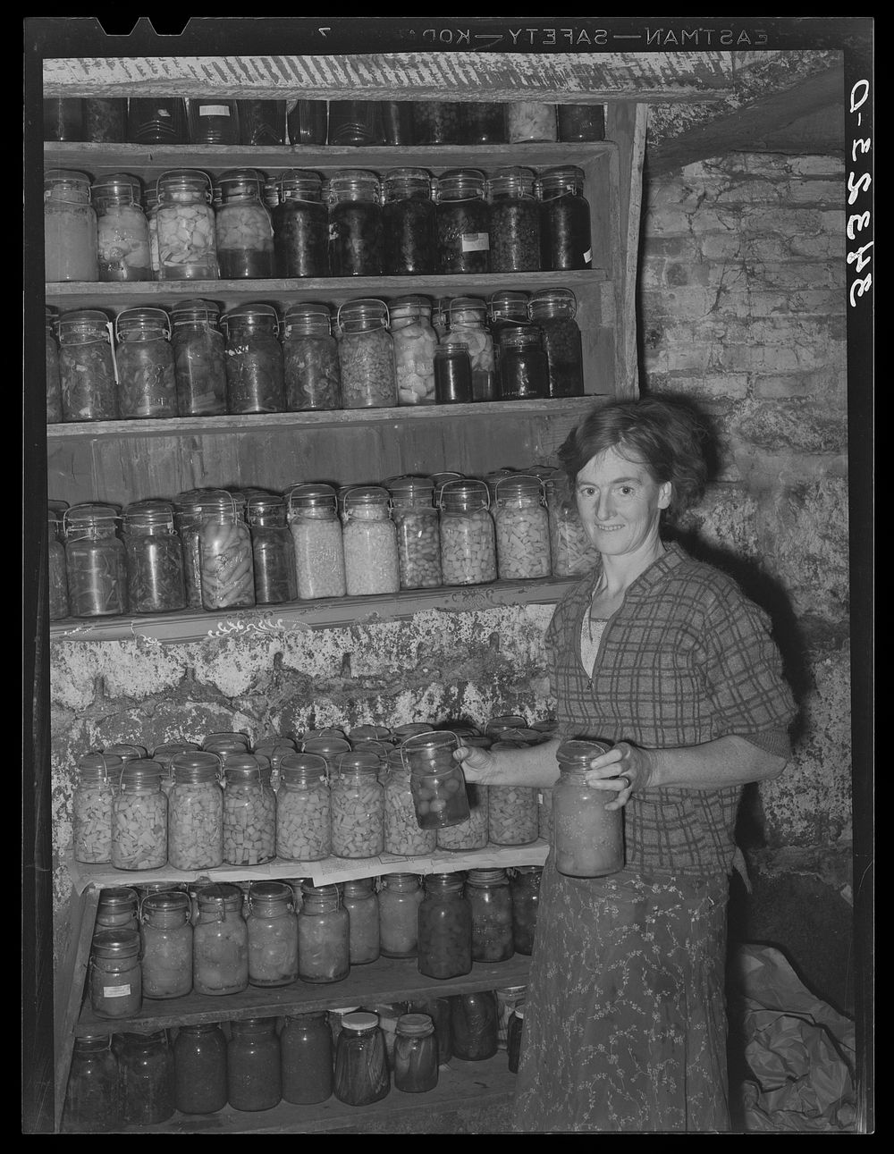 FSA (Farm Security Administration) client with canned goods. Farm, Bradford, Vermont, Orange County by Russell Lee