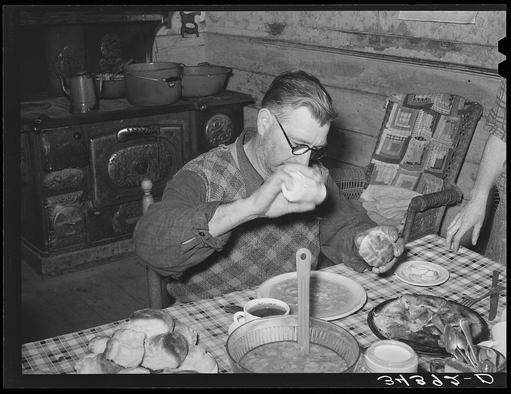 Salting his beans. Farmer in Orange County near Bradford, Vermont by Russell Lee