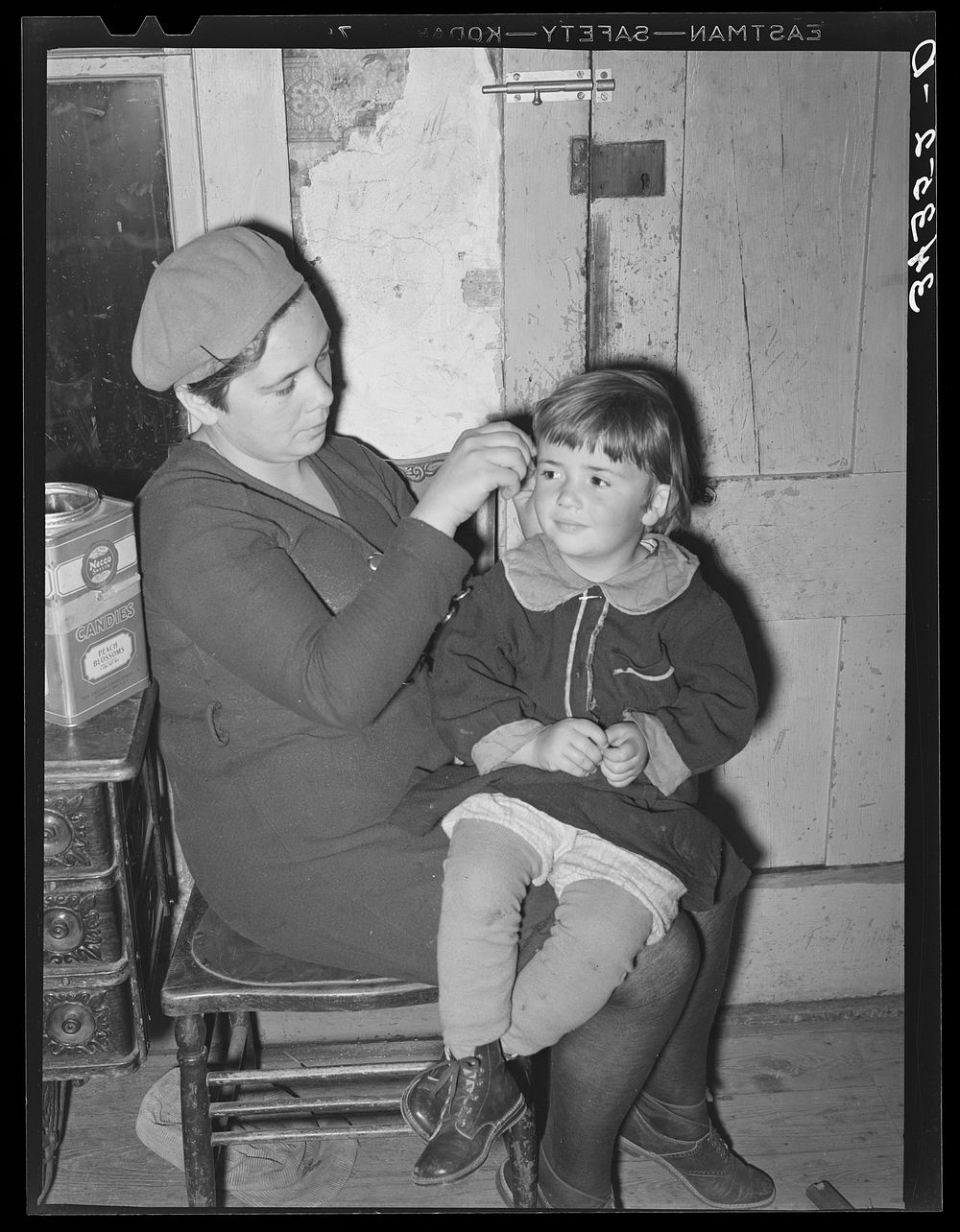 Wife of FSA (Farm Security Administration) client fixing her daughter's hair. Farm near Bradford, Vermont, Orange County by…