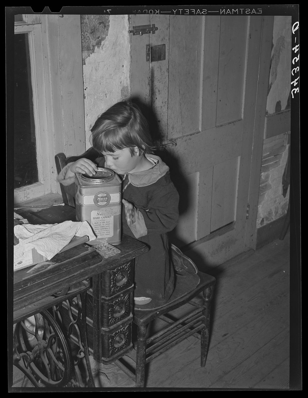 [Untitled photo, possibly related to: Daughter of FSA (Farm Security Administration) client looking into candy jar. Farm…