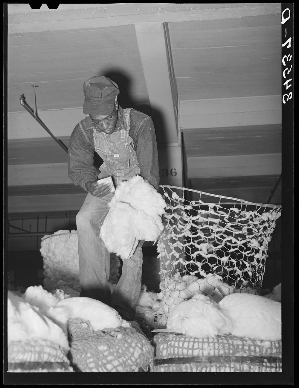 Tagging samples of cotton. Compress, Houston, Texas by Russell Lee