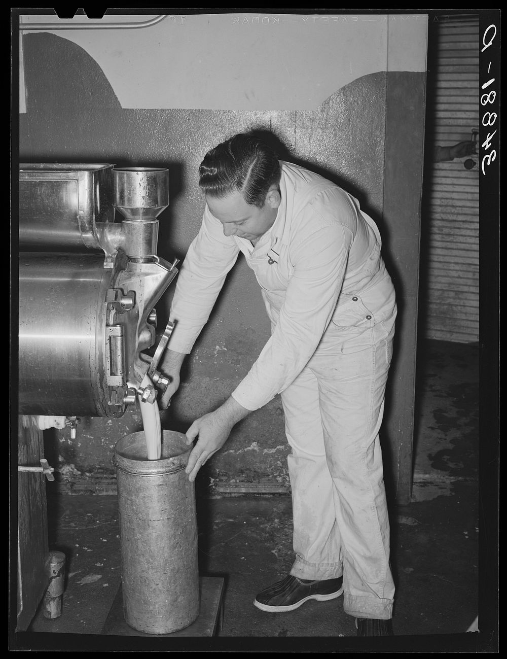 [Untitled photo, possibly related to: Filling can with ice cream mix. Creamery, San Angelo, Texas. Later it will be placed…