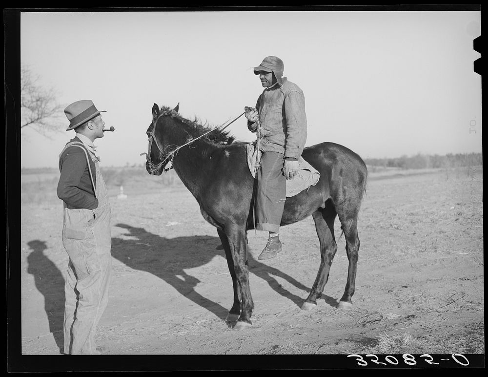 Pomp Hall,  tenant farmer, talking to a neighbor who has ridden up on horseback. Creek County, Oklahoma. See general caption…