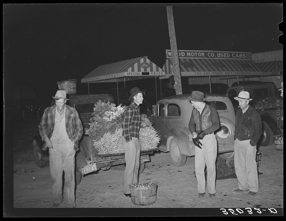 Early morning vegetable market. San Angelo, Texas. The farmers with their hands in their pockets show how cold the wind was…