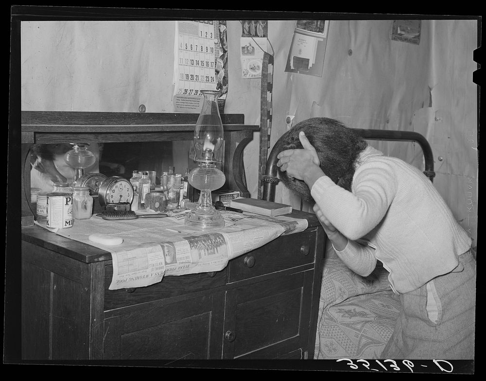 Wife of Pomp Hall,  tenant farmer, combing her hair in the morning. Creek County, Oklahoma. See general caption number 23 by…