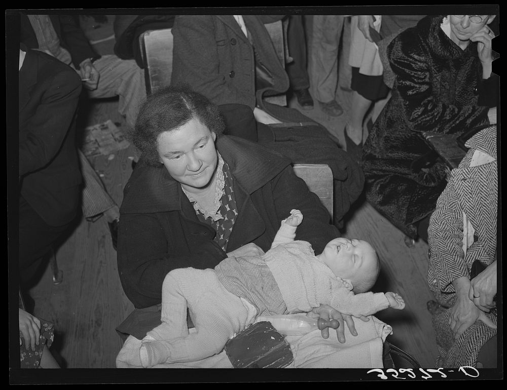Farm woman with baby at pie supper at the school house. Muskogee County, Oklahoma. See general caption number 24 by Russell…