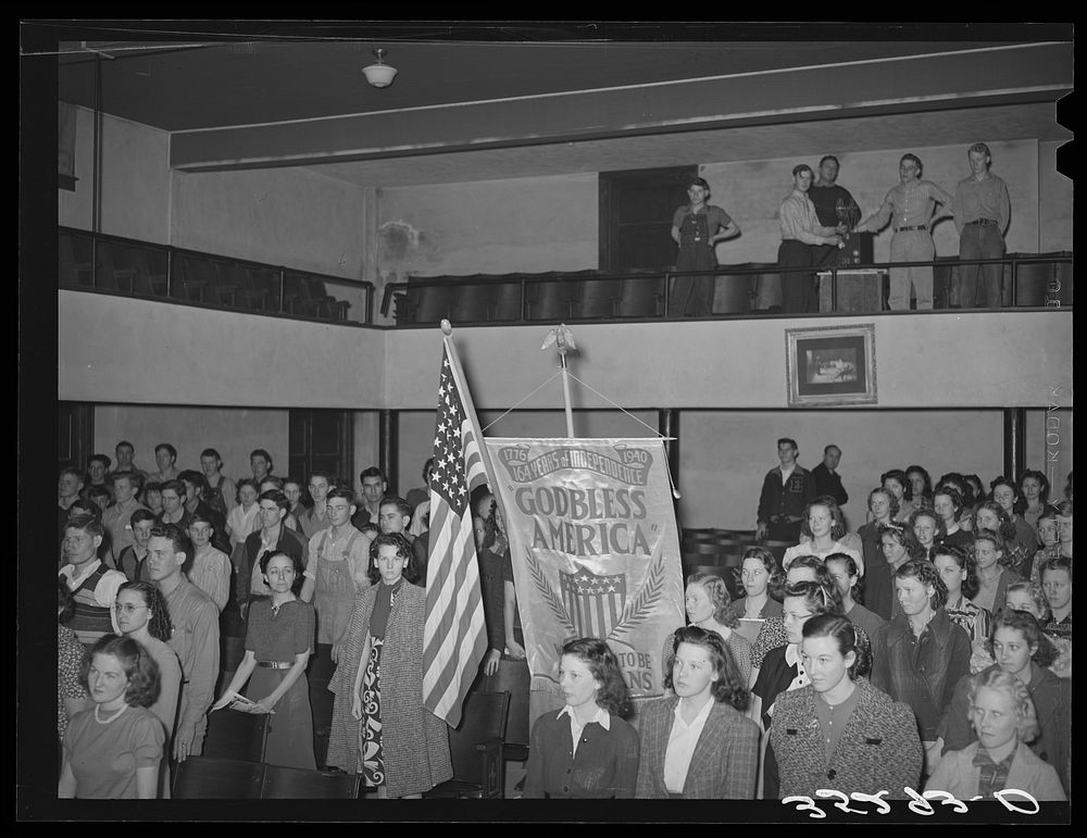 Americanization program at high school opened with boy scouts carrying flag and banner down the center aisle. Eufaula…