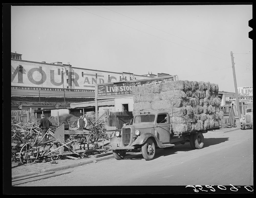 Truckload of feed in front of farm implement store. Oklahoma City, Oklahoma by Russell Lee