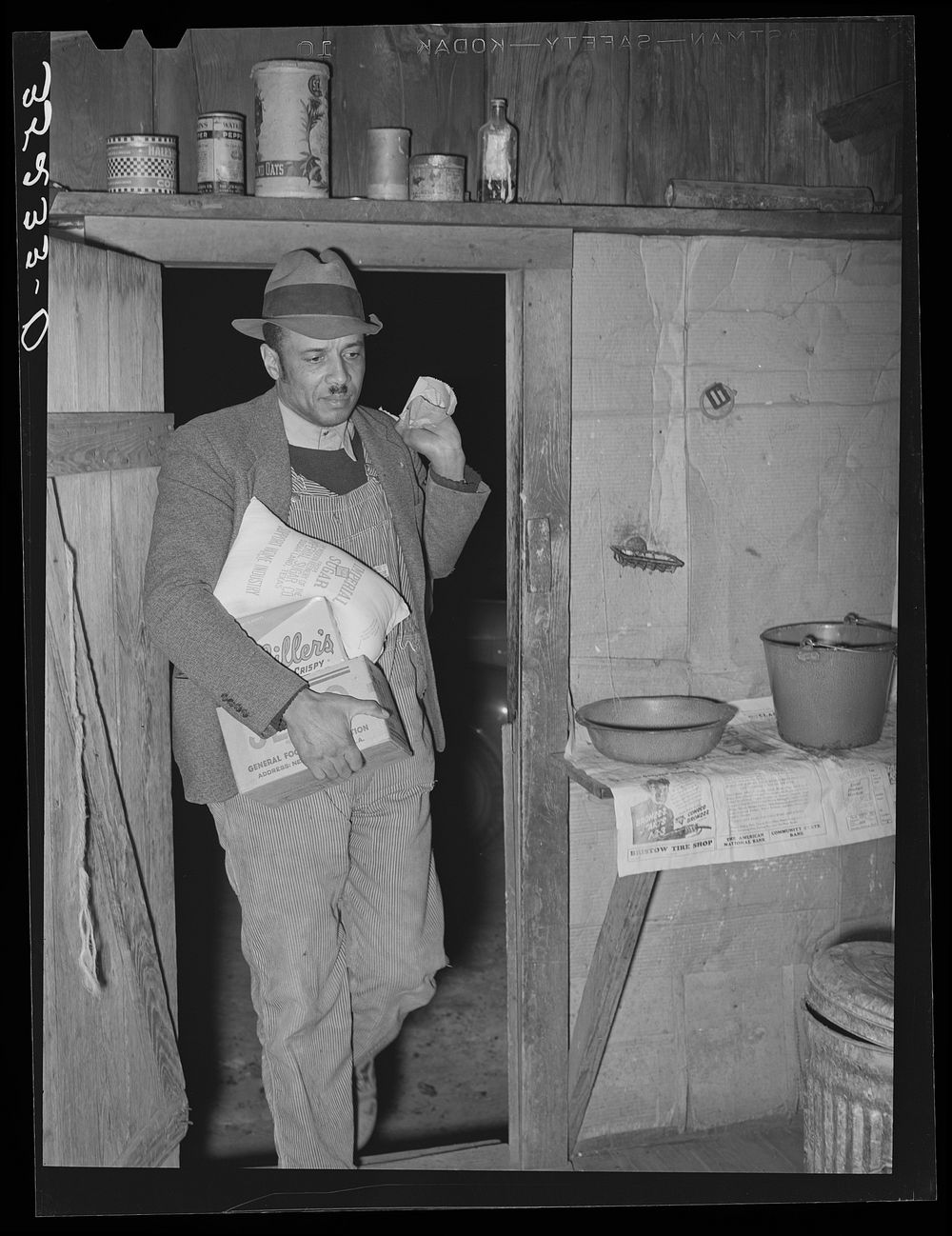 Pomp Hall,  tenant farmer, coming in the kitchen door carrying seed and groceries which he bought in Tulsa. Creek County…
