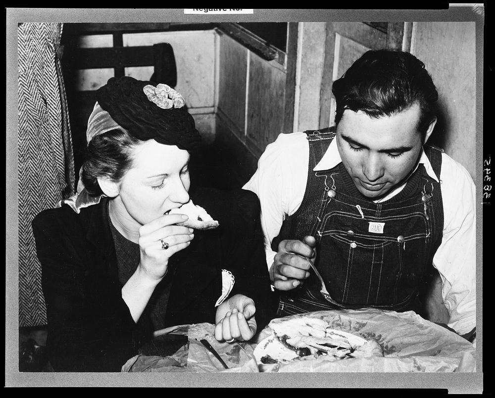 Farm boy eating pie which he bought at auction and which was made by the girl with whom he is eating. Muskogee County…