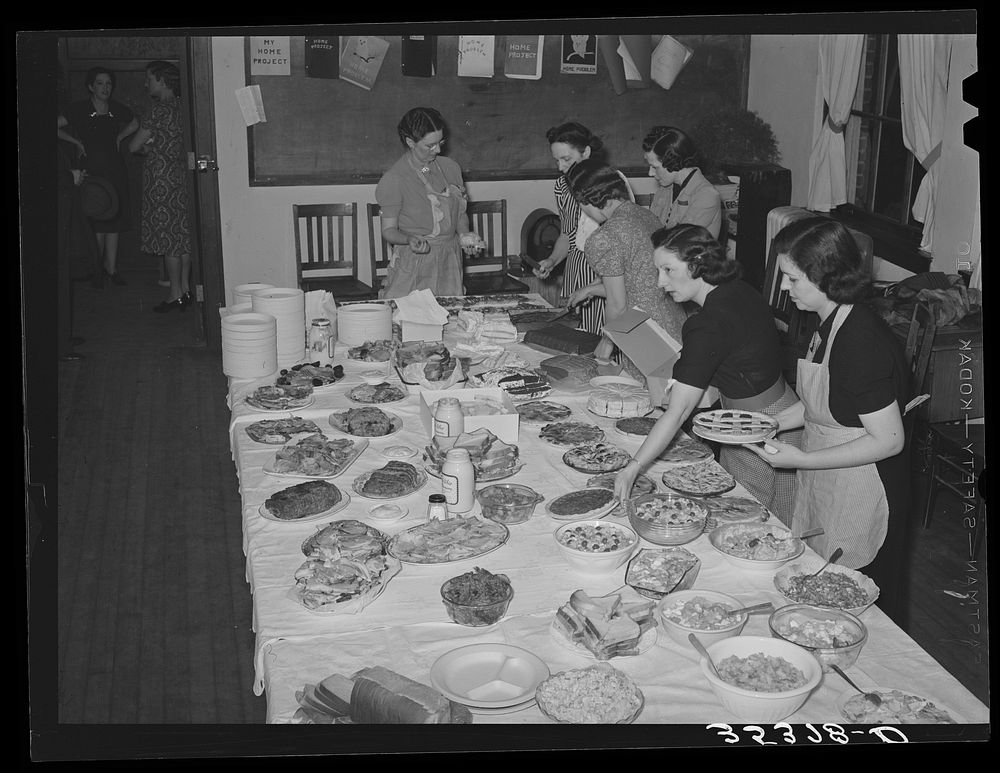 Arranging food on table at buffet supper of the Jaycees at Eufaula, Oklahoma. See general caption number 25 by Russell Lee