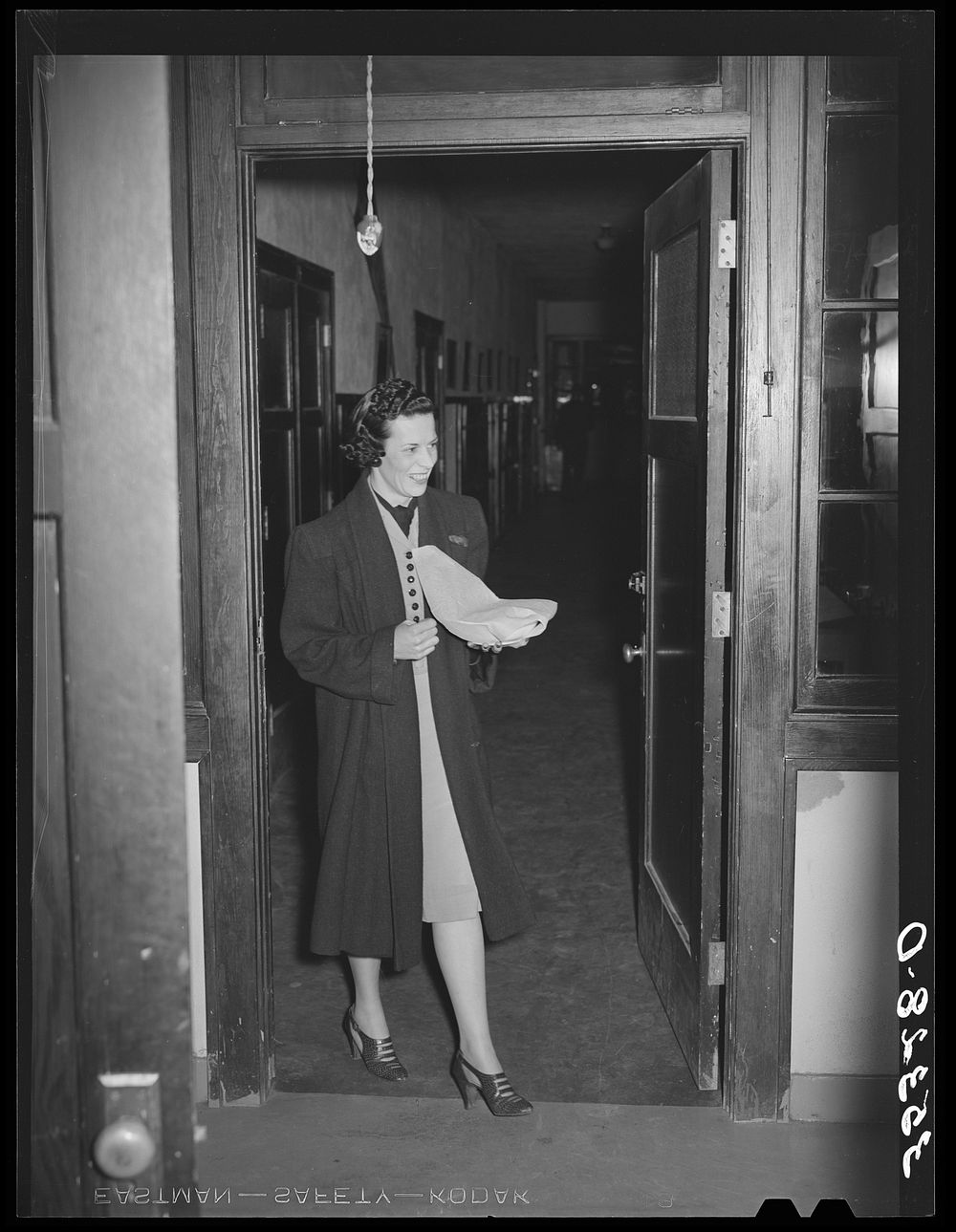 Wife of Jaycee member bringing food to the buffet supper at the high school. Eufaula, Oklahoma. See general caption 25 by…
