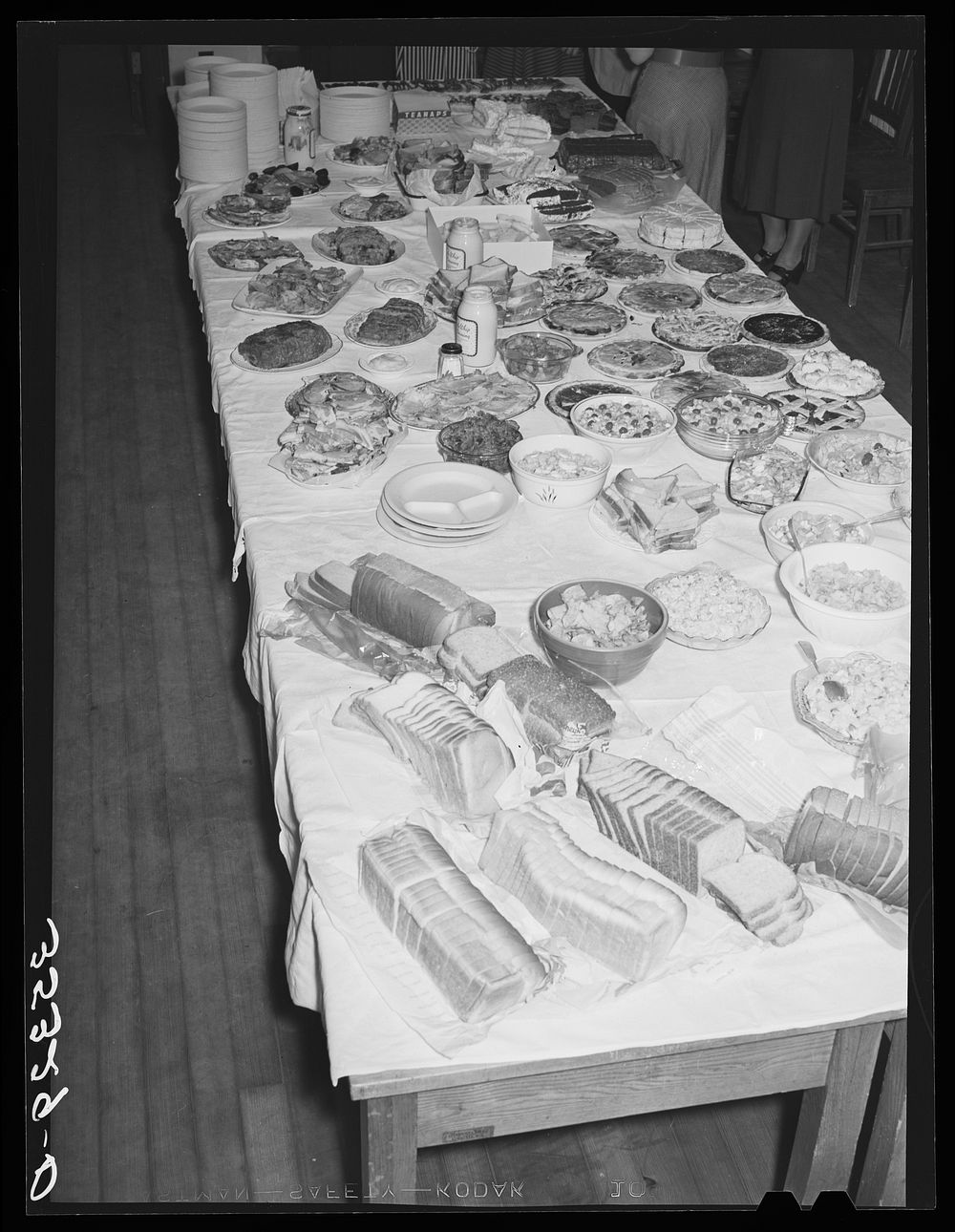 Table loaded with food, Jaycee buffet supper. Eufaula, Oklahoma. See general caption number 25 by Russell Lee