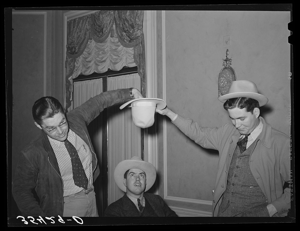 Young men drawing numbers from a hat at a contest at the Junior Chamber of Commerce luncheon. San Angelo, Texas by Russell…