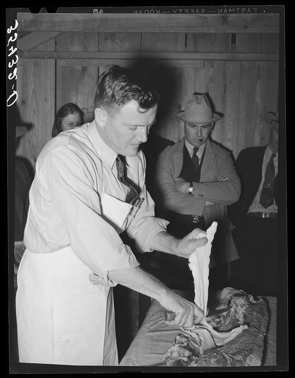 FSA (Farm Security Administration) supervisor who was formerly a meat cutter in a large packing plant giving an exhibition…