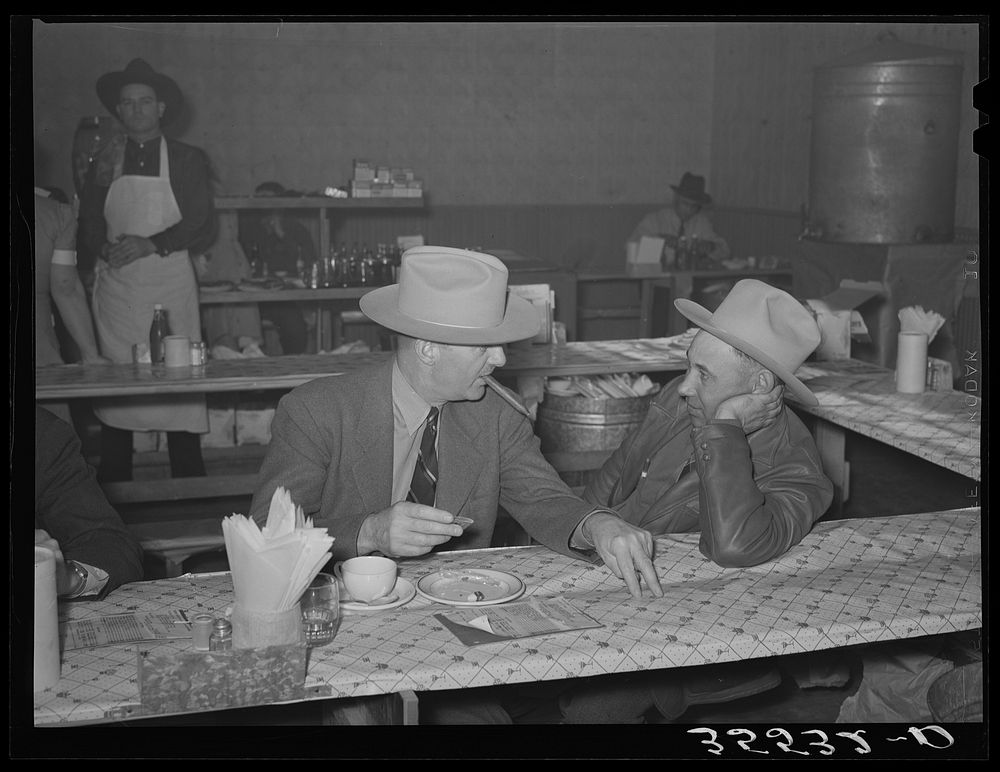 Cattlemen talking after lunch in a restaurant on the grounds of the San Angelo Fat Stock Show. San Angelo, Texas by Russell…