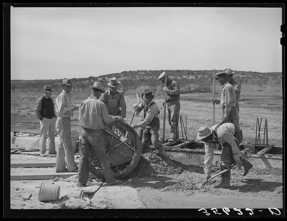 Road workers at the concrete mixing cart. Menard County, Texas by Russell Lee