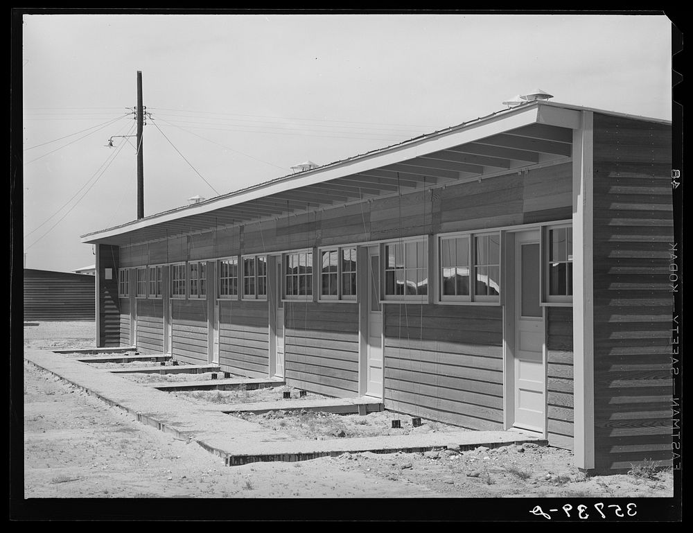 Front of row shelter for migratory workers at the migratory labor camp. Sinton, Texas by Russell Lee