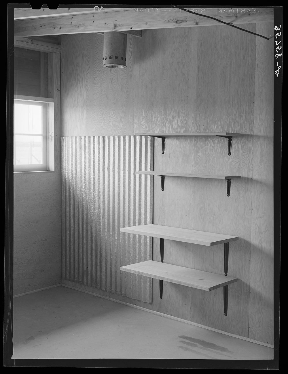 Shelves which will serve as storage space for kitchen equipment in one of the row shelters for migratory workers at the…