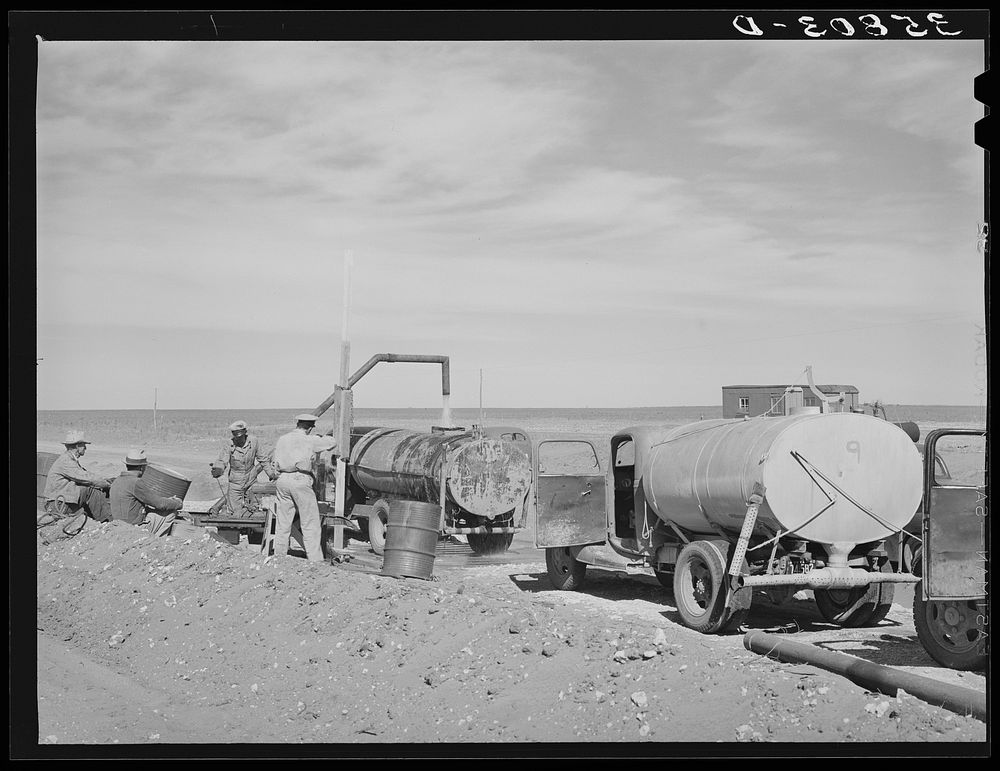 Filling tanks with water to be used in road construction. Gaines County, Texas by Russell Lee
