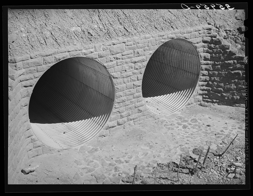 Conduits under the highway to carry off flood waters, thus protecting the highway. U.S. 60, Navajo County, Arizona by…
