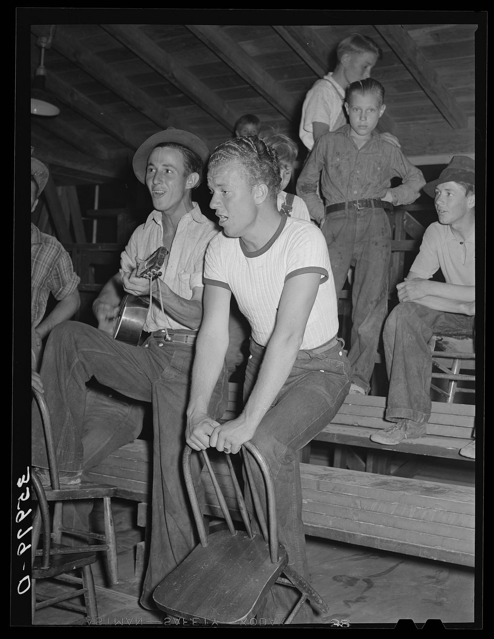 Young migratory agricultural workers singing at the Saturday night dance at the Agua Fria migratory labor camp, Arizona by…