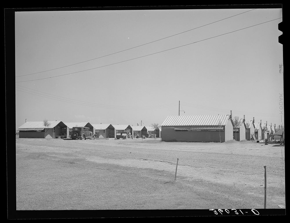 [Untitled photo, possibly related to: Rows of metal shelters for agricultural workers at the Aqua Fria migratory labor camp.…