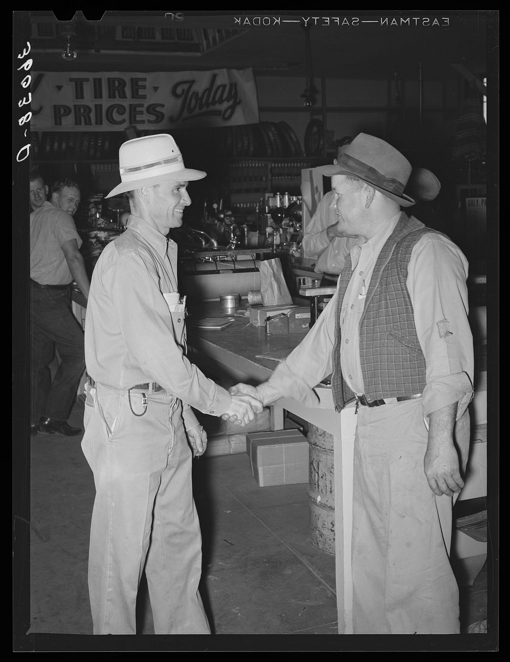 Two farmers meet and shake hands at the United Producers and Consumers Cooperative. Phoenix, Arizona by Russell Lee