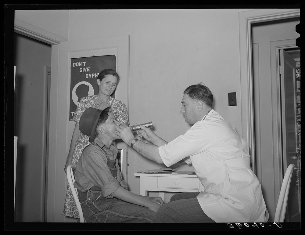 Examination by doctor at the clinic of the Agua Fria migratory labor camp. Arizona by Russell Lee