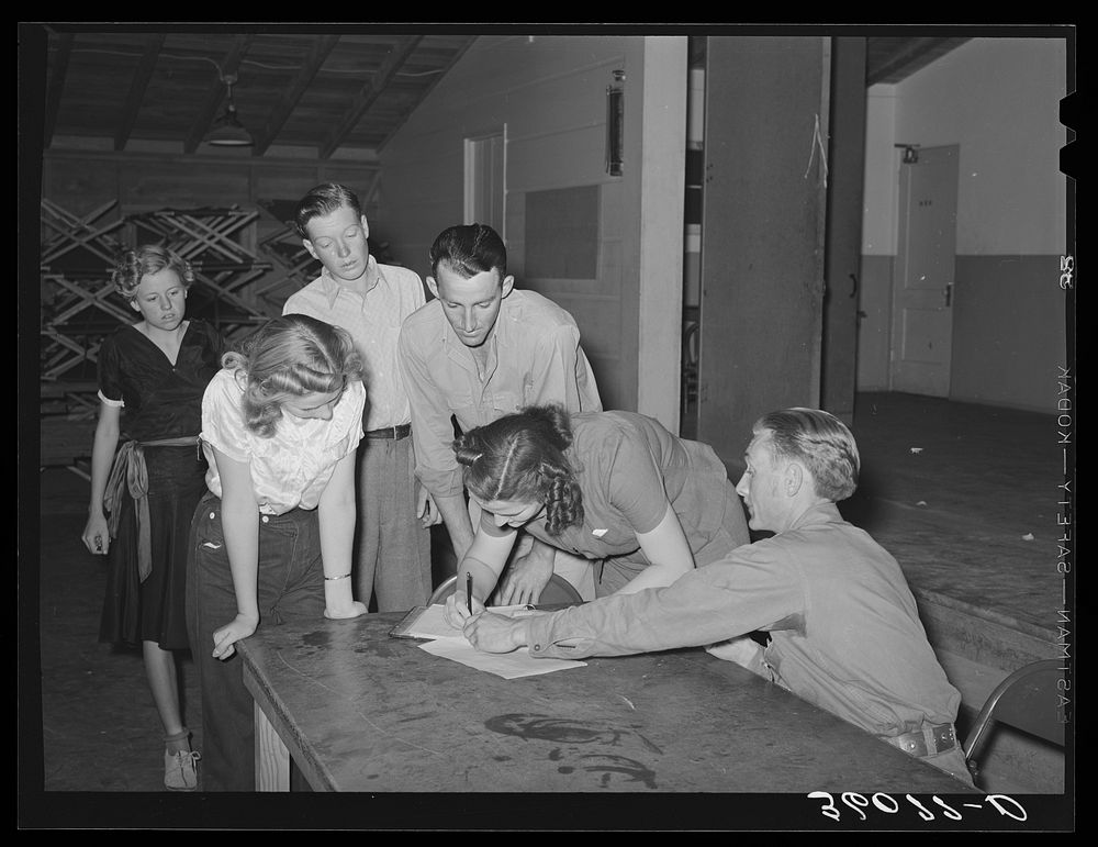 New members signing up at the young people's club at the Agua Fria migratory labor camp. Arizona by Russell Lee