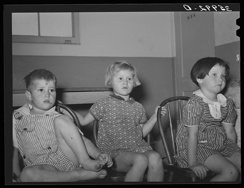 Children of migratory laborers listening to a story at the WPA (Work Projects Administration) nursery school at the Aqua…