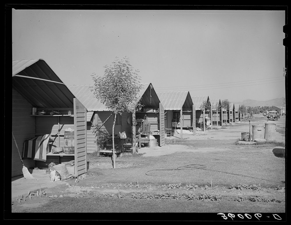 Rows of metal shelters for agricultural workers at the Aqua Fria migratory labor camp. Arizona by Russell Lee