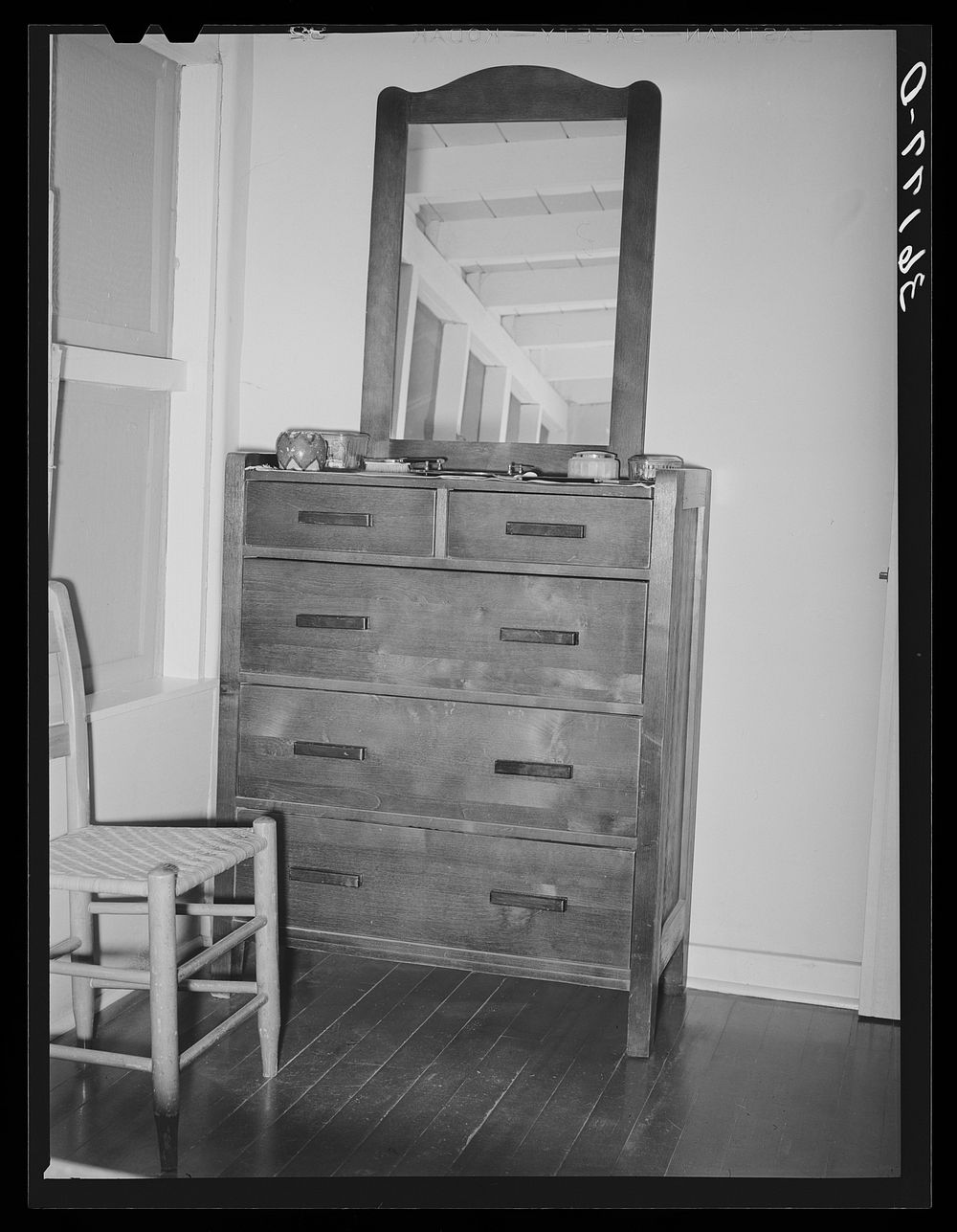 Dresser in bedroom of an apartment at the Arizona part-time farms. Maricopa County, Arizona. The furniture in the apartment…