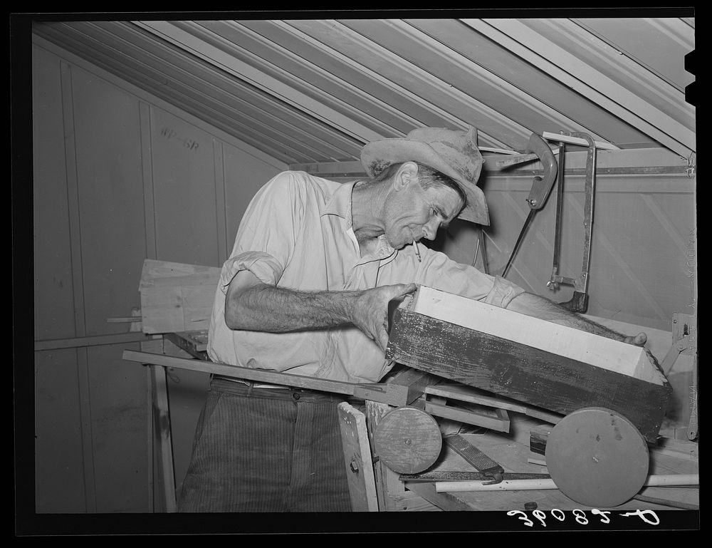 Migratory agricultural laborer making toys for the WPA (Work Projects Administration) nursery school at the Agua Fria…