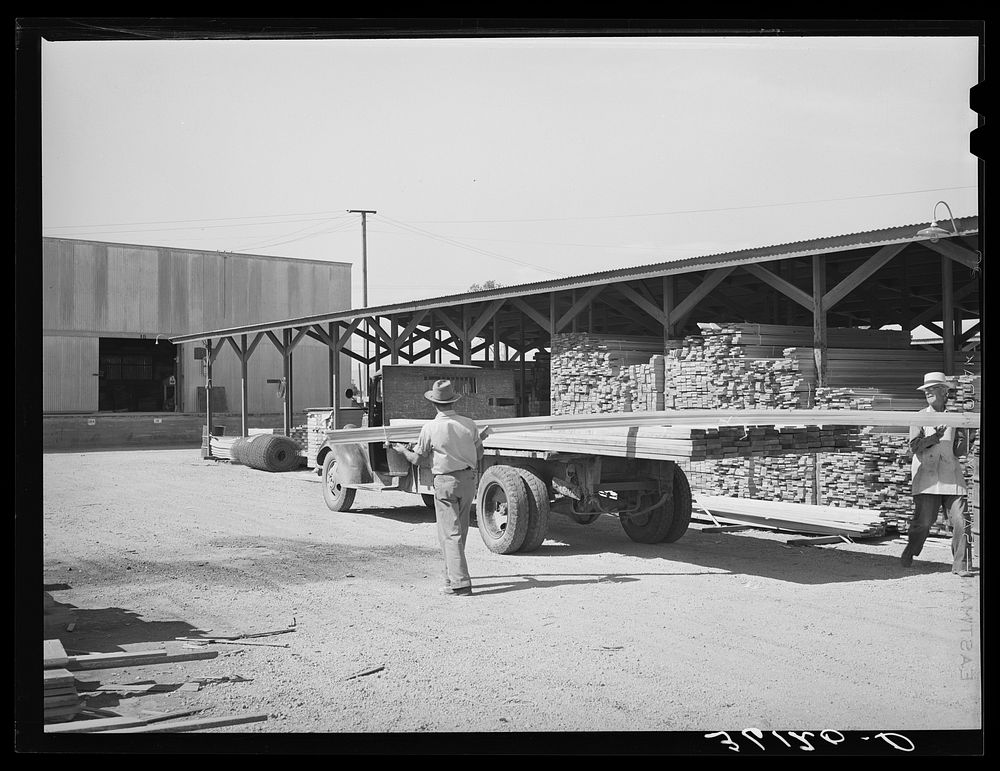 [Untitled photo, possibly related to: Lumber being loaded onto truck at the Producers and Consumers Cooperative. Phoenix…