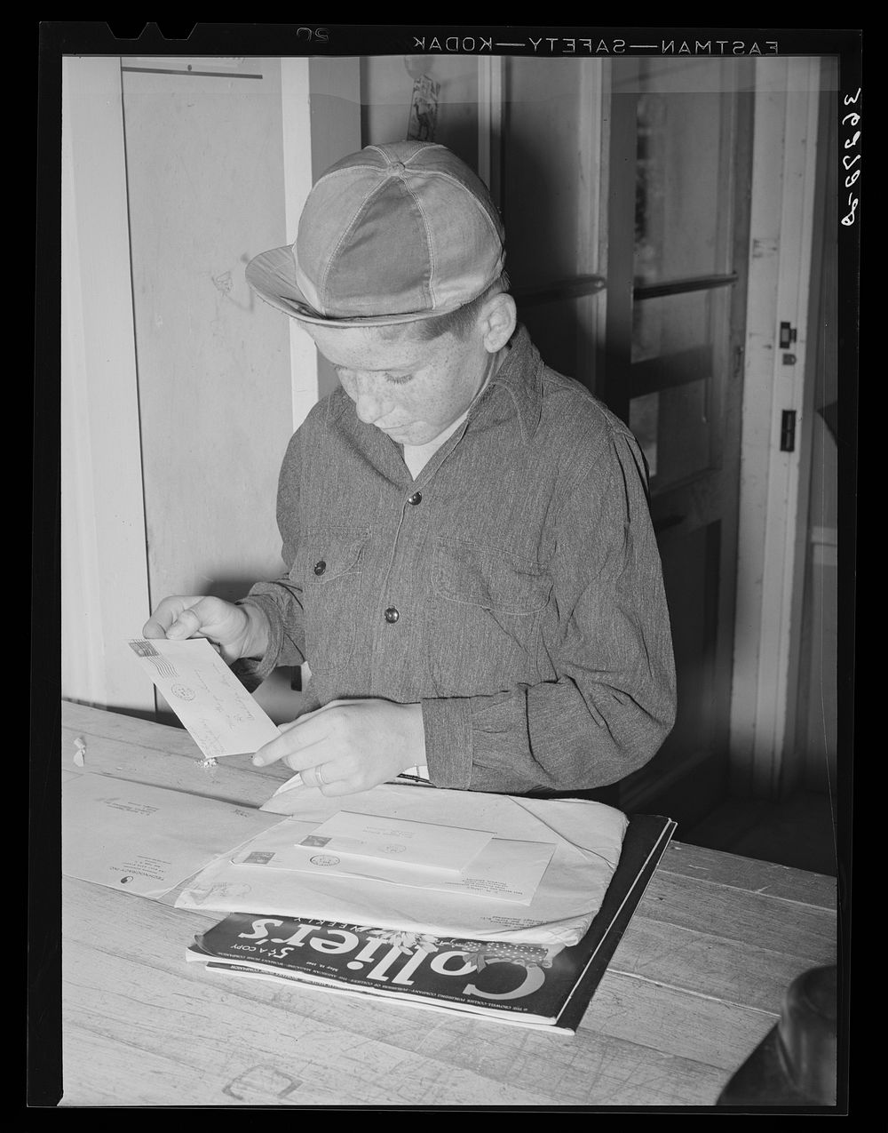 Little boy receiving his family's mail at the post office of the Casa Grande Valley Farms. Pinal County, Arizona by Russell…
