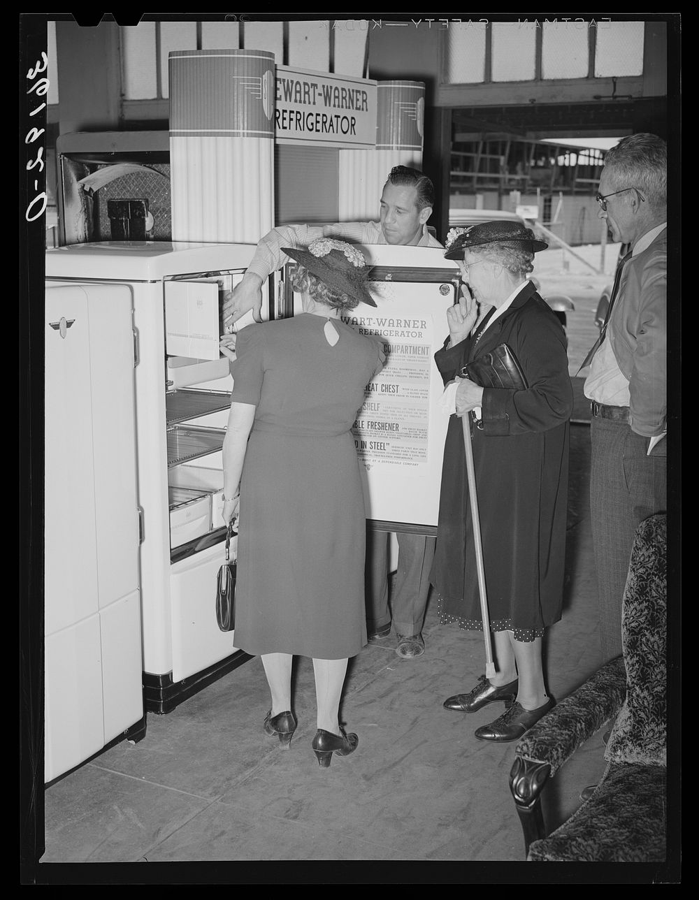 Salesman demonstrating an electric refrigerator to members of the United Producers and Consumers Cooperative of Phoenix…