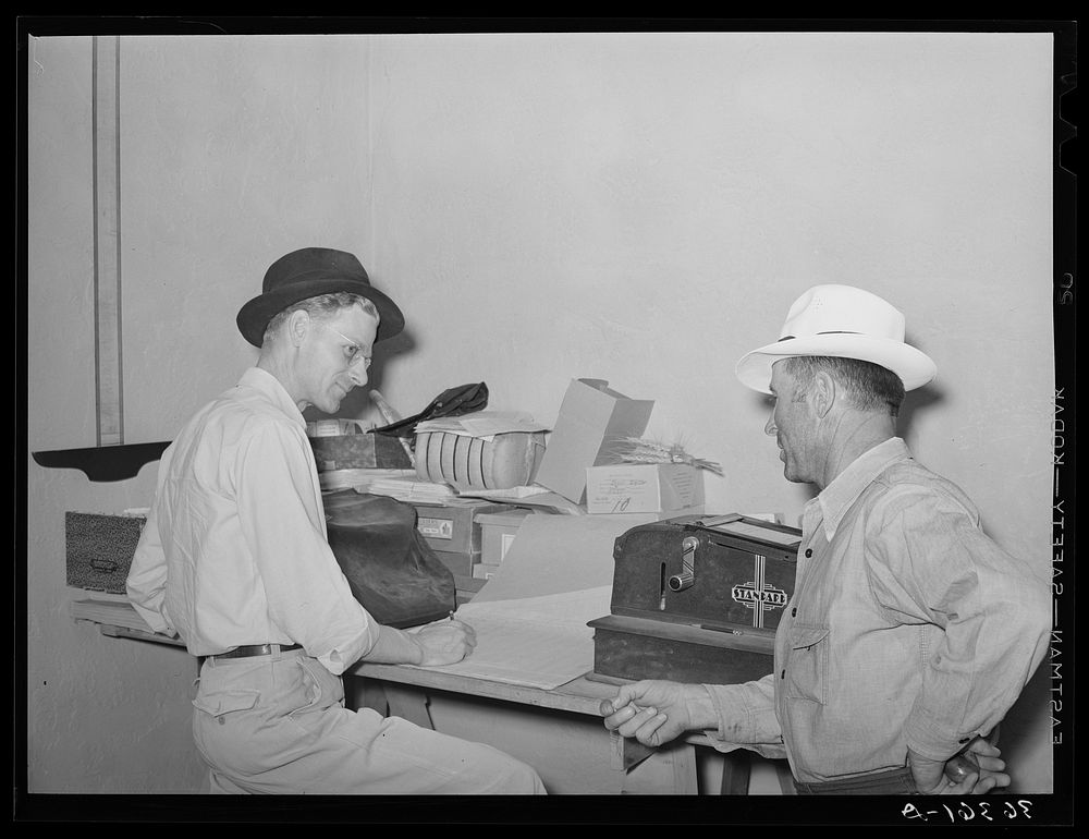Assistant manager of the Casa Grande Valley Farms, Pinal County, Arizona, discussing a report with a member of the…