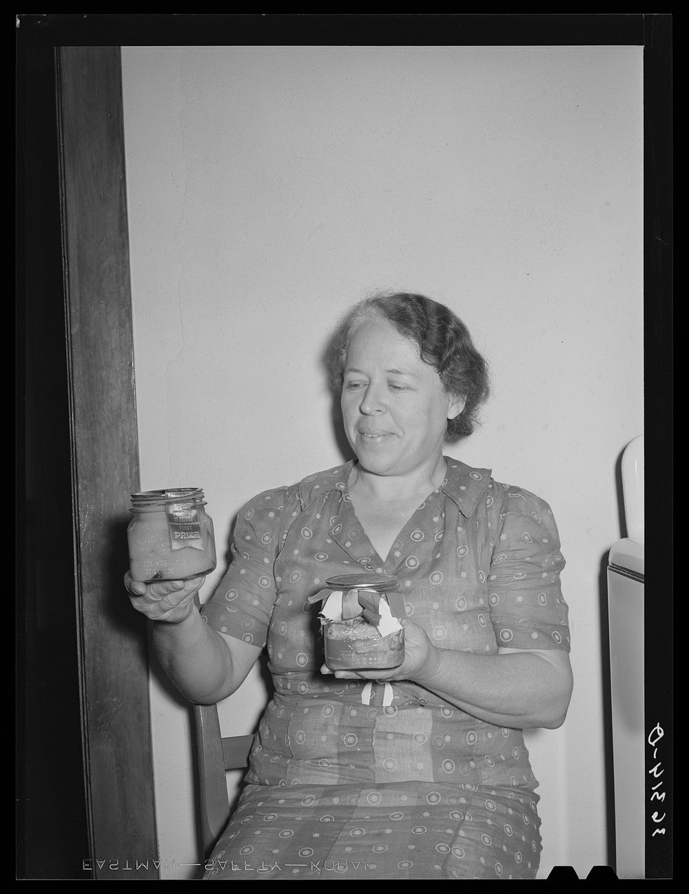 Wife of member of the Casa Grande Valley Farms, Pinal County, Arizona, displaying canned fruit with which she won first…