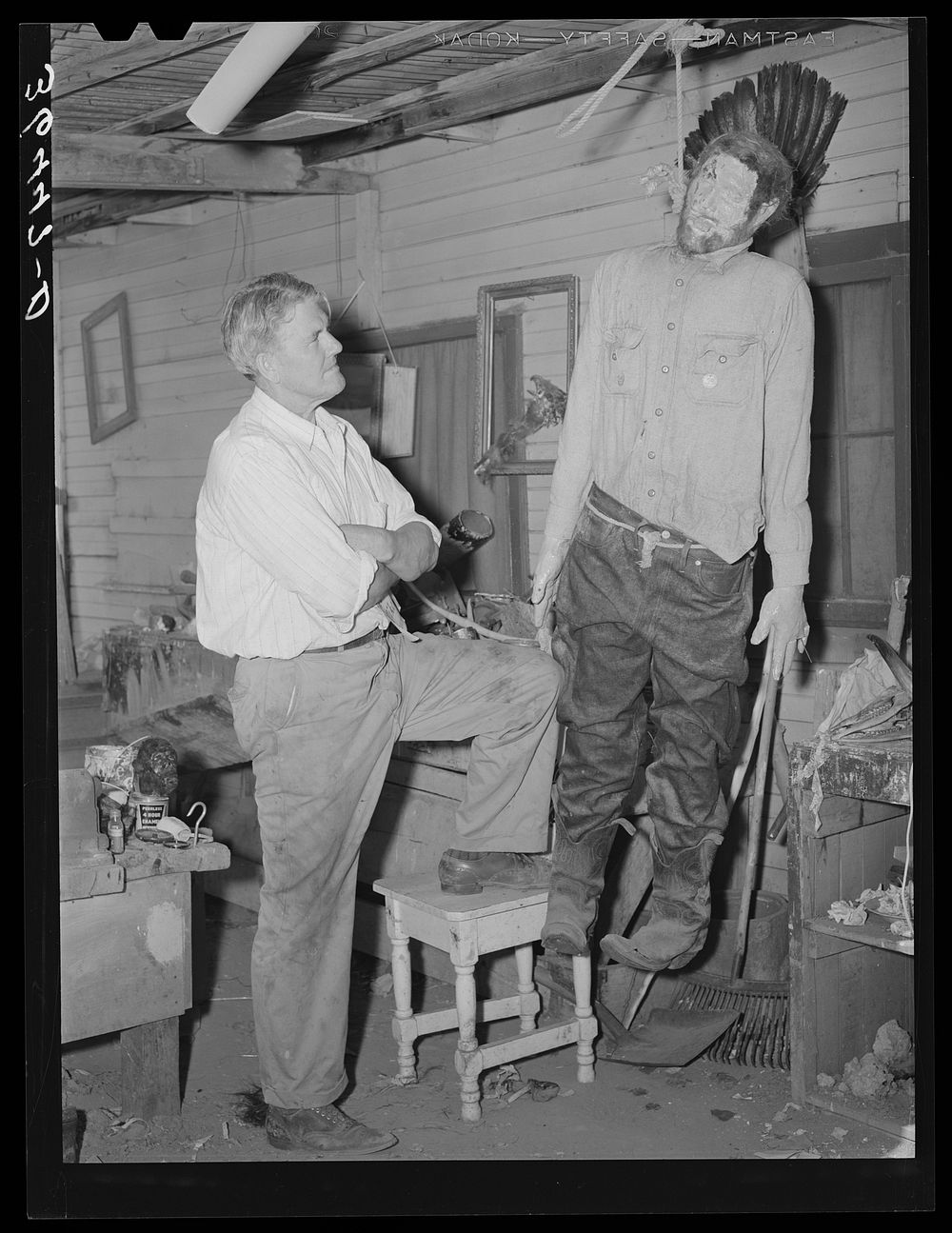 Homer Tate, self-trained artist, looking at his model of a hanged horse thief. Safford, Arizona by Russell Lee