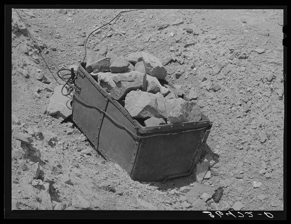 Old ore bucket and gold ore at abandoned gold mine at Pinos Altos, New Mexico by Russell Lee