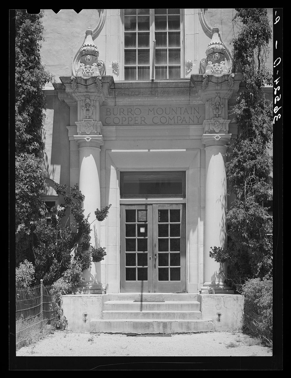 [Untitled photo, possibly related to: Entrance to offices of Burro Mountain Copper Company. Tyrone, New Mexico. This copper…