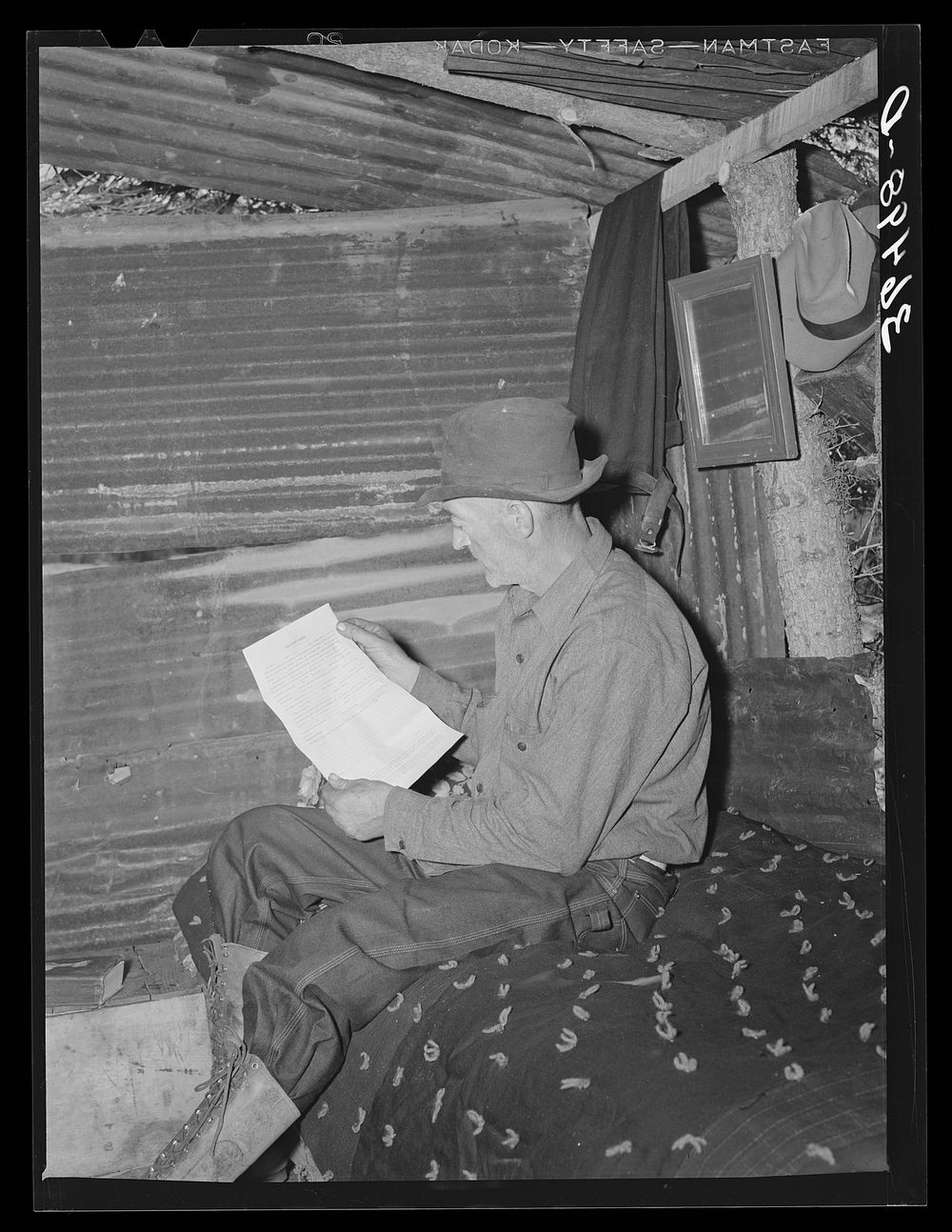 Eugene Davis, gold prospector, reading over location notice form which must be filed along with mining claim. Pinos Altos…