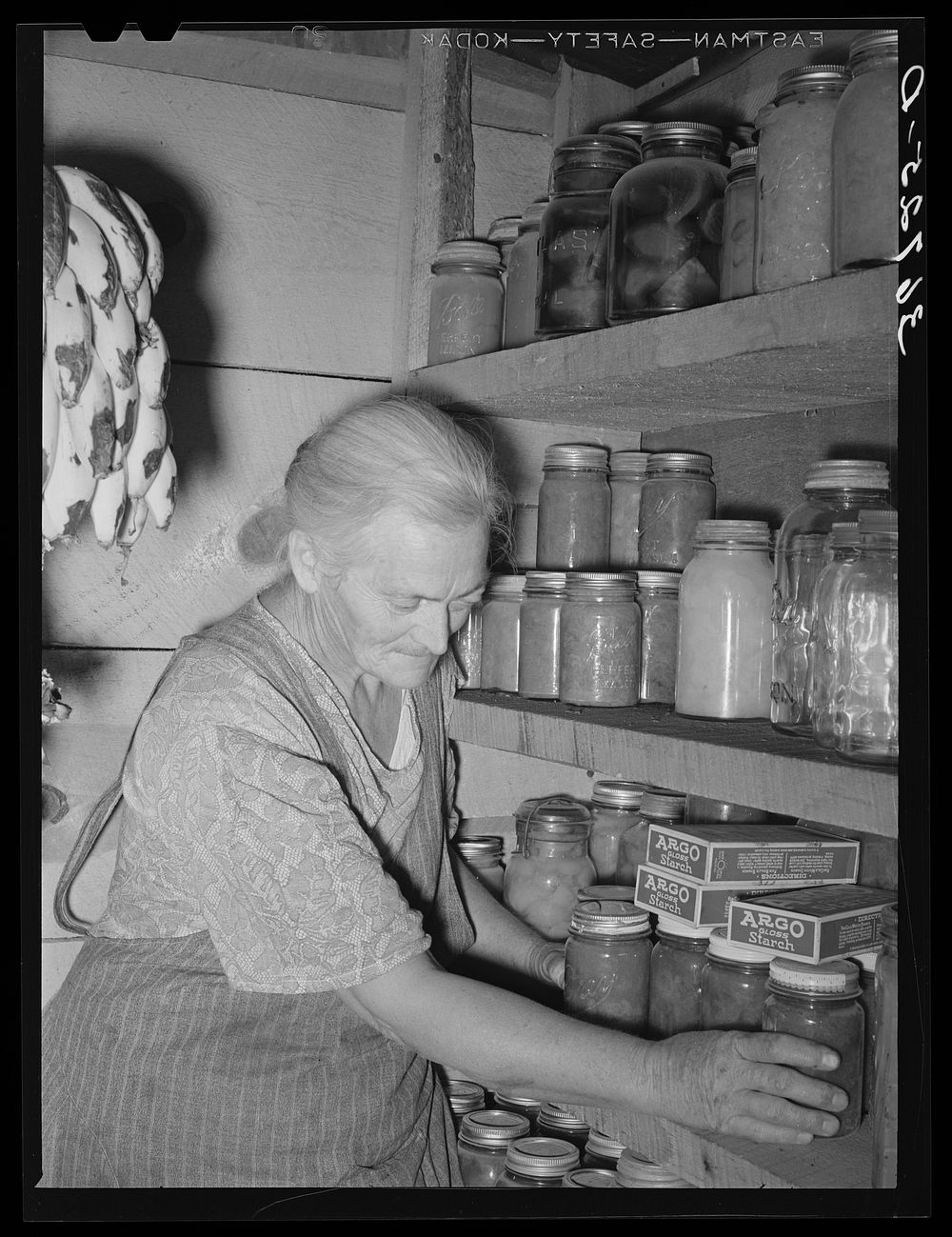 Mrs. Hutton in her storage cellar. Mrs. Hutton said, "You know it seems like a farm is the place for us old folks. In town…