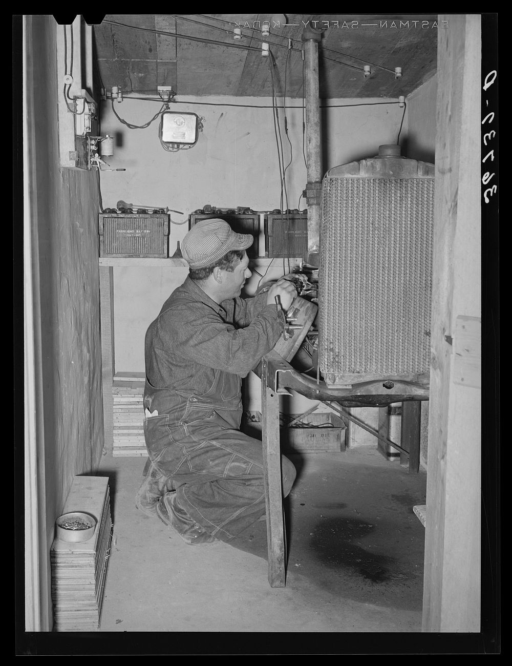 George Hutton, Jr., working on his homemade electric plant. Hutton took a correspondence course in electricity and has…