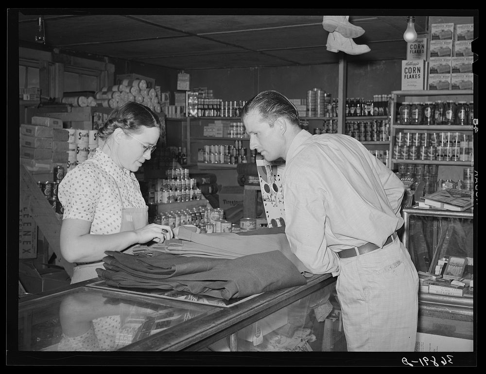 The clerk and a customer in the general store. Mogollon, New Mexico by Russell Lee
