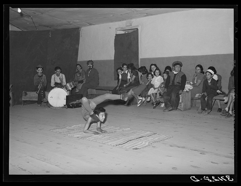Acrobat and audience at Spanish-American traveling show. Penasco, New Mexico by Russell Lee