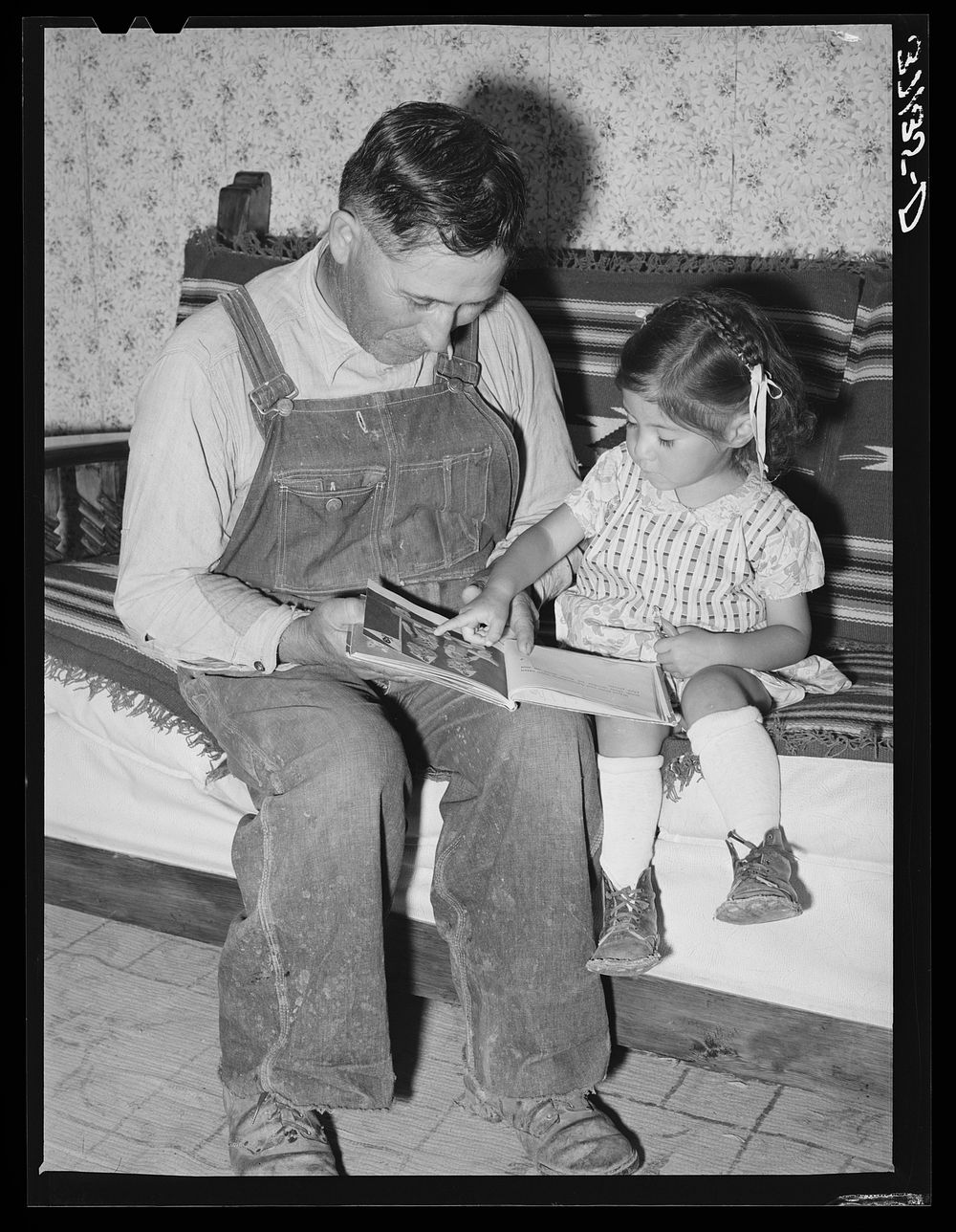 Spanish-American farmer and his daughter. Chamisal, New Mexico by Russell Lee