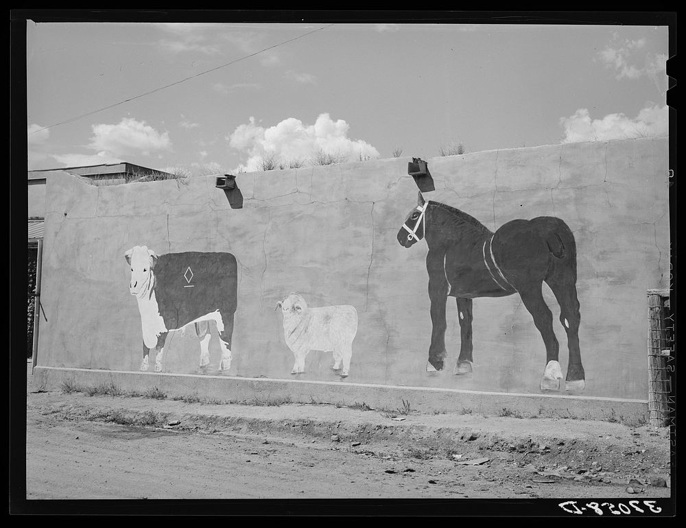 Native art on adobe wall. Amalia, New Mexico by Russell Lee